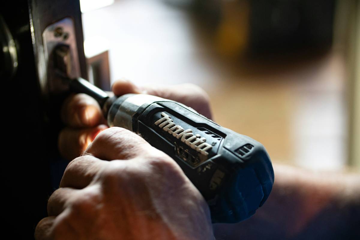 Professional using a brad nailer gun on interior trim installation
