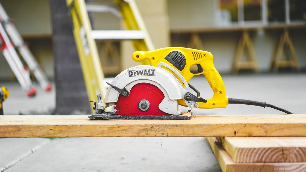 Professional using first fix nail guns on construction site framing walls
